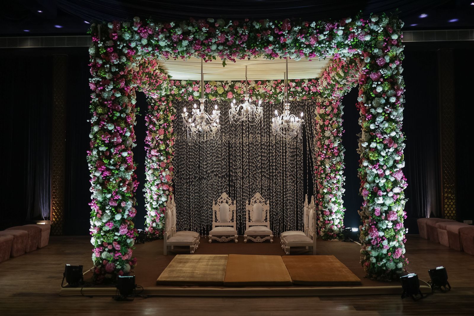 Ornate wedding mandap decorated with vibrant flowers for the ceremony