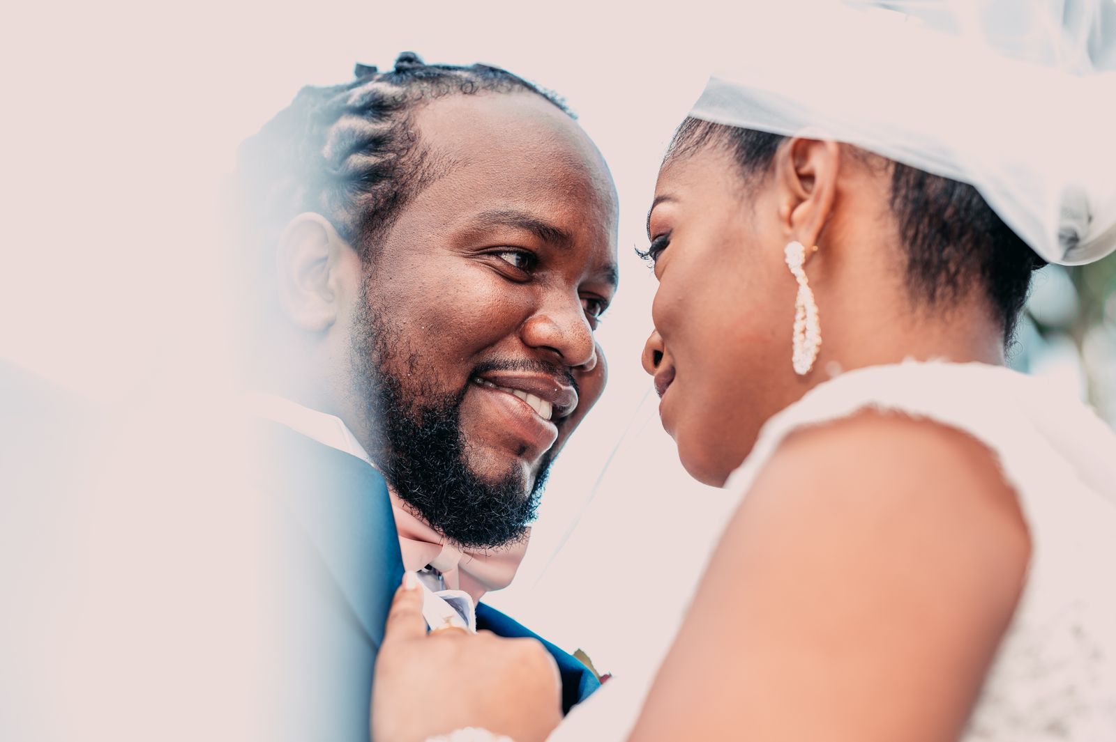 Happy bride and groom posing together in a warm wedding portrait